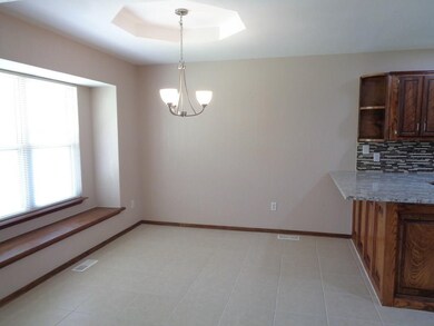 Dining room.  New lighting, tile flooring, and windows.