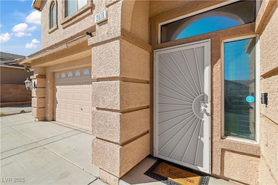 Entry to property featuring concrete driveway and stucco exterior