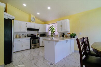 Large kitchen with newer quartz counters. Appliances stay with sale