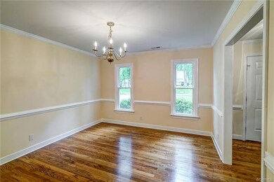 Dining room has hardwood floors, chair rail and cr