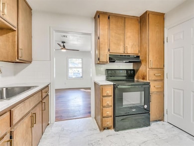 Kitchen with a ceiling fan, under cabinet range ho