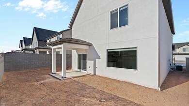 Rear view of property featuring a patio area, stucco siding, and a residential view
