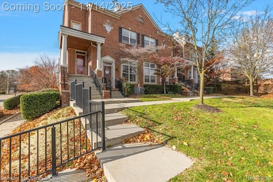 View of front of house with a front yard and brick siding