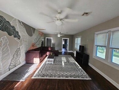 Living room featuring ceiling fan and original har