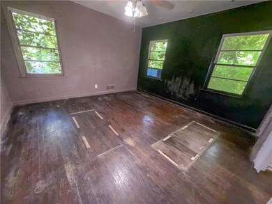 Unfurnished room featuring visible vents, wood fin
