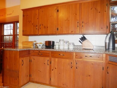 Kitchen with Wood Cabinetry, Granite Counters and 