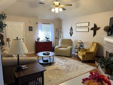 Living room with hardwood / wood-style floors, a f