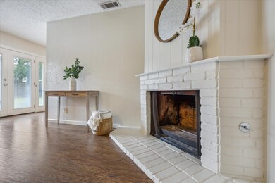 Unfurnished living room featuring a brick firepla