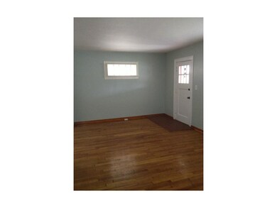 View of entry & beautiful wood flooring from firep