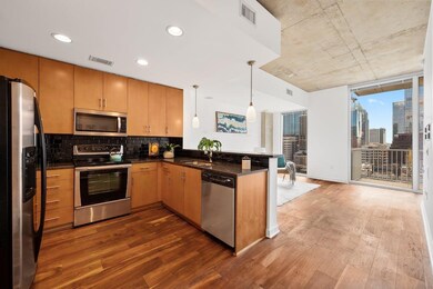 Kitchen with stainless steel appliances, dark woo