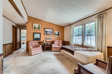 Bedroom featuring wood walls, a textured ceiling,