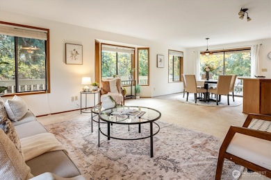 The open living and dining space welcomes natural light throughout the day with wide windows that draw the pastoral landscape inside.