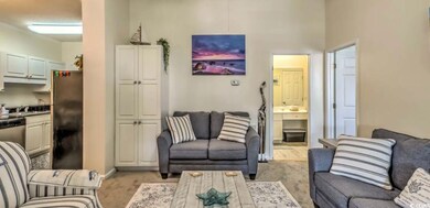 Living room with baseboards and light carpet