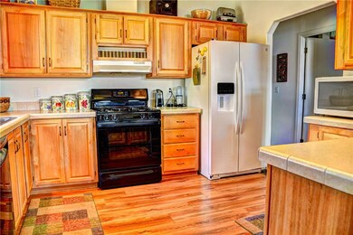 Spacious kitchen with custom hardwood cabinets.