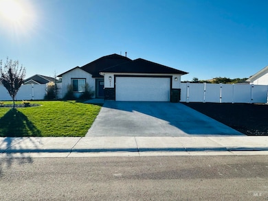 Single story home featuring a gate, concrete driveway, and an attached garage