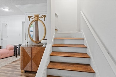 Staircase with wood finished floors, ornamental mo