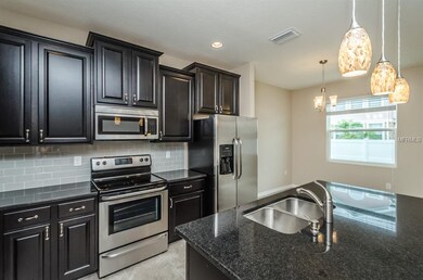 Enjoy modern espresso cabinets and granite counter