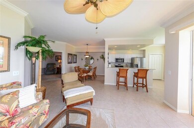 Tiled living room with ceiling fan, ornamental mol