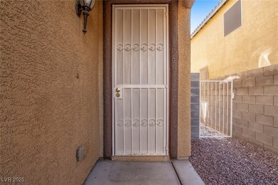 Property entrance with stucco siding and fence