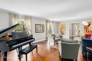 Formal living room with large windows.