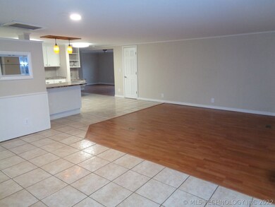 View from entry; Large living area with laminate f