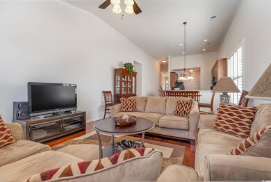 Living room featuring crown molding, vaulted ceili