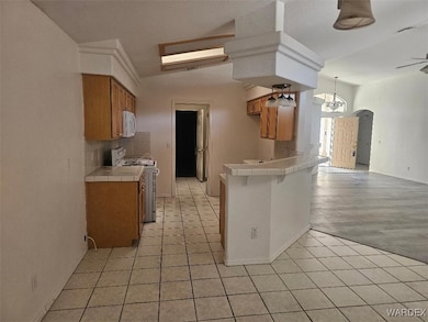 Kitchen featuring tile countertops, brown cabinetr
