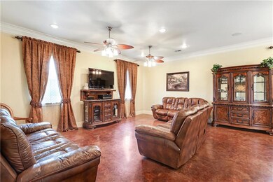 Spacious living area with stained concrete floors