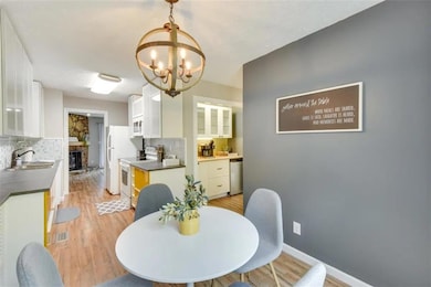 Dining space with light wood-style flooring and a chandelier