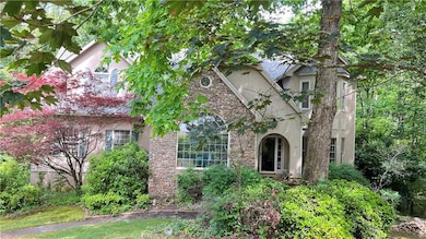 View of front of home featuring stucco siding and stone siding