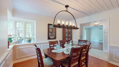 Dining space with wood ceiling, crown molding, and