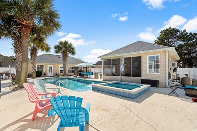 View of pool featuring a patio area, a sunroom, an