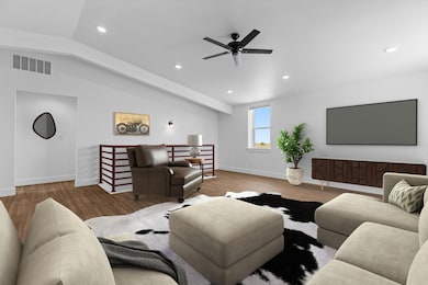 Living area with a ceiling fan, visible vents, wo