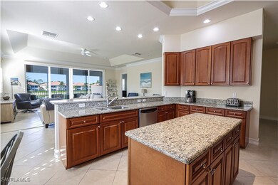Kitchen with light tile patterned floors, dishwasher, a center island, sink, and ceiling fan