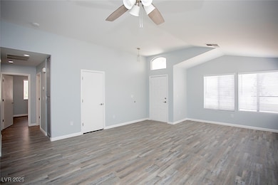 Living room with fresh paint and vaulted ceiling a