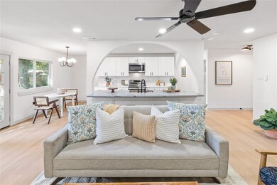 Living room featuring sink, light hardwood / wood-