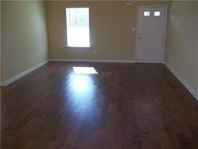 Large great room with hardwood flooring.