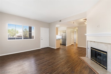 Unfurnished living room featuring a fireplace and dark wood finished floors
