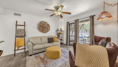 Sitting room with wood finished floors and ceiling fan