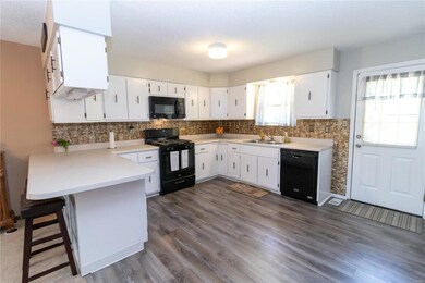 Huge kitchen with tons of cabinets, breakfast bar and new flooring!