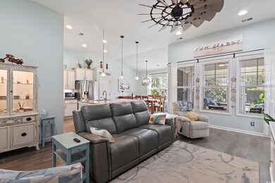 Living room featuring lofted ceiling, ceiling fan,