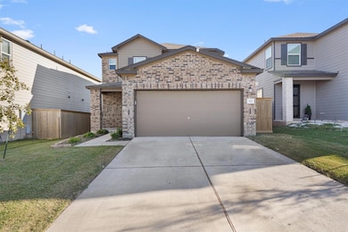 Traditional home with brick siding, concrete driveway, and a garage