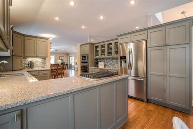 GREY CABINETRY AND BEAUTIFUL QUARTZ COUNTERS