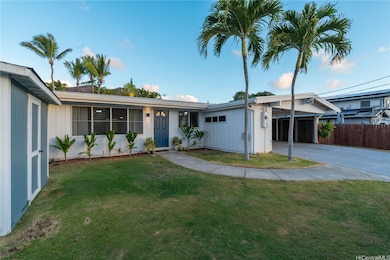 Front of house with yard and storage shed.
