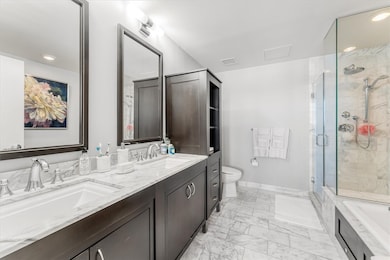 Primary bathroom with shower stall and soaking tub