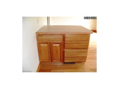 Kitchen island area with breakfast bar on other si