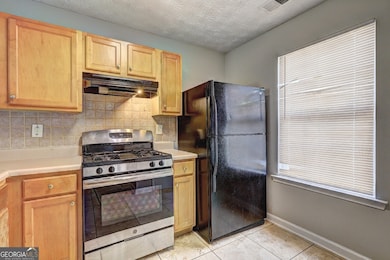 The kitchen from the foyer with pantry on right (o