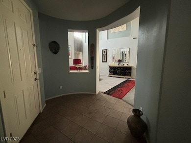 Corridor with dark tile patterned flooring and bas