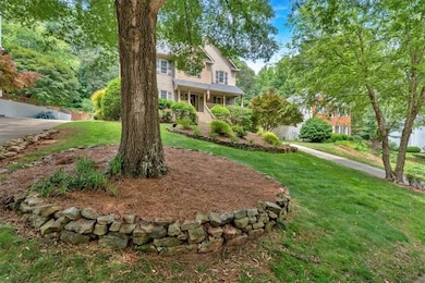 View of front of house featuring a front lawn, a porch, and stairway