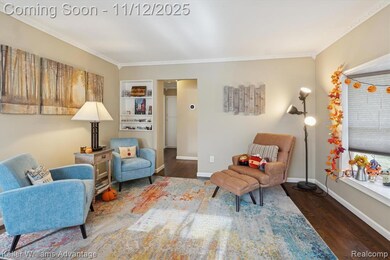 Living area with dark wood-style floors and crown molding